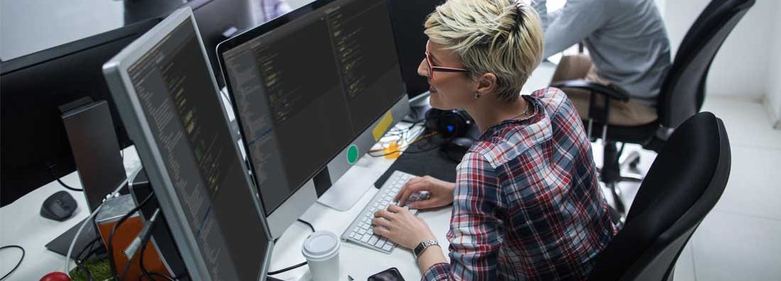 Female computer programmer working on computer. Find Computer Programmer & IT Consultant Insurance.