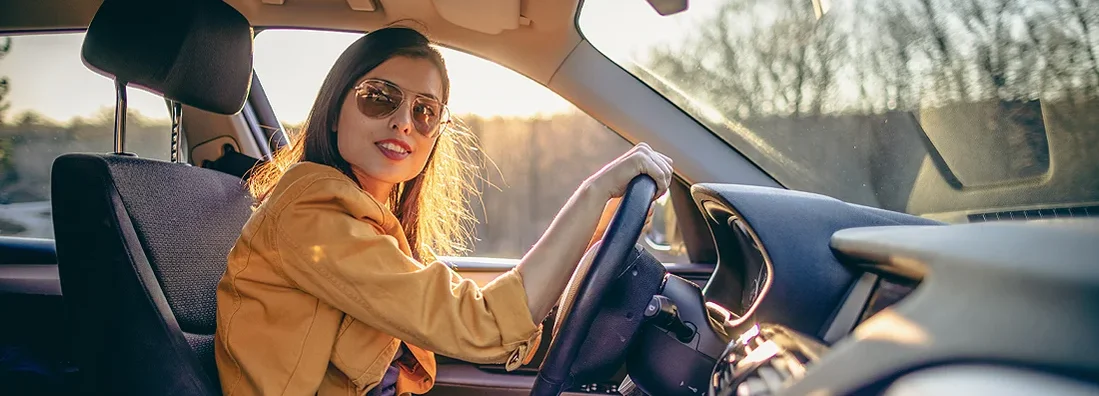 Young woman driving car on a sunny day. How to Find the Best Car Insurance in Narberth, Pennsylvania.