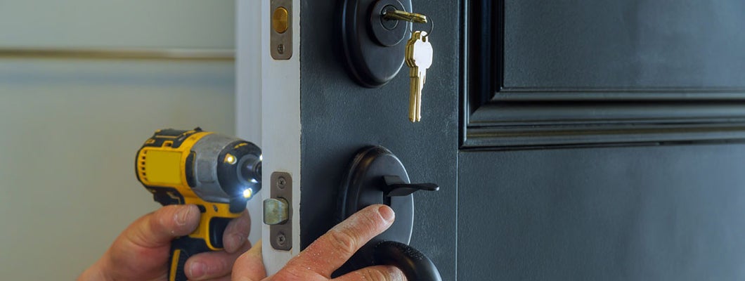 Professional locksmith installing a new deadbolt lock. Ways your home insurance is draining your savings.