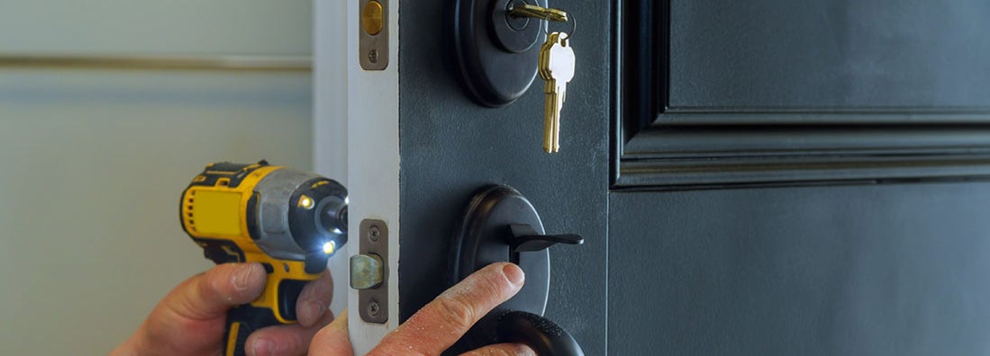 Professional locksmith installing a new deadbolt lock. Ways your home insurance is draining your savings.