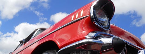 Close up of a beautifully restored 1957 Chevy Bel Air convertible, as seen at a car show. 