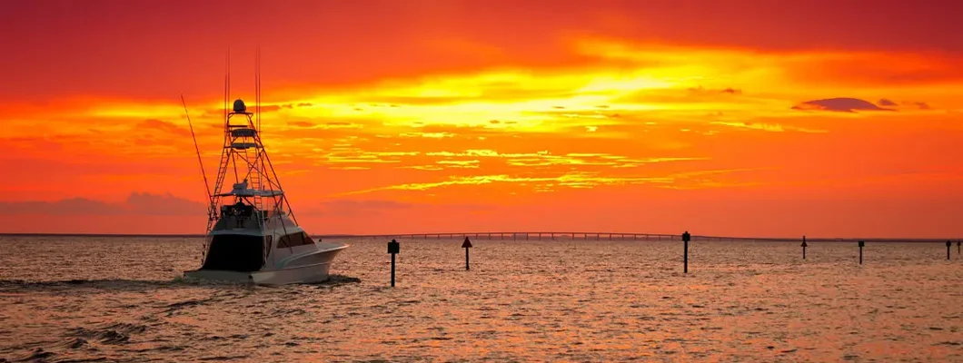 Large fishing boat going out for a sunset cruise in Destin, Florida. Find Alabama Boat Insurance.