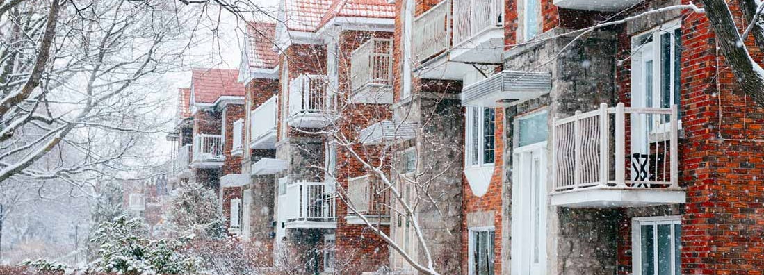 Residential Condominium Buildings on Snowy Winter Day. Find Vermont condo insurance.