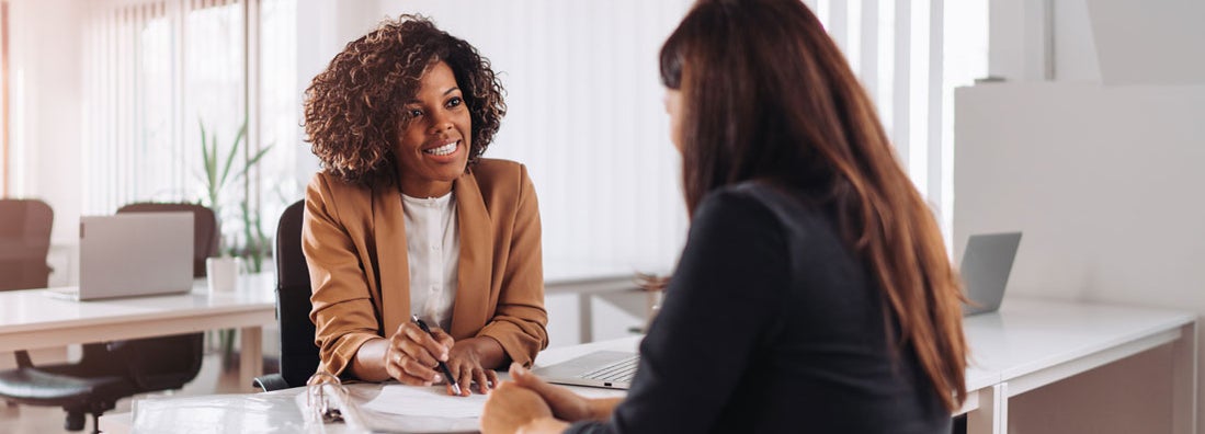 Woman consulting with an independent insurance agent. How to cut insurance costs by a ton.