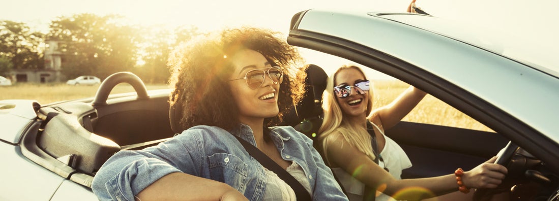 Young adults traveling in car and having fun