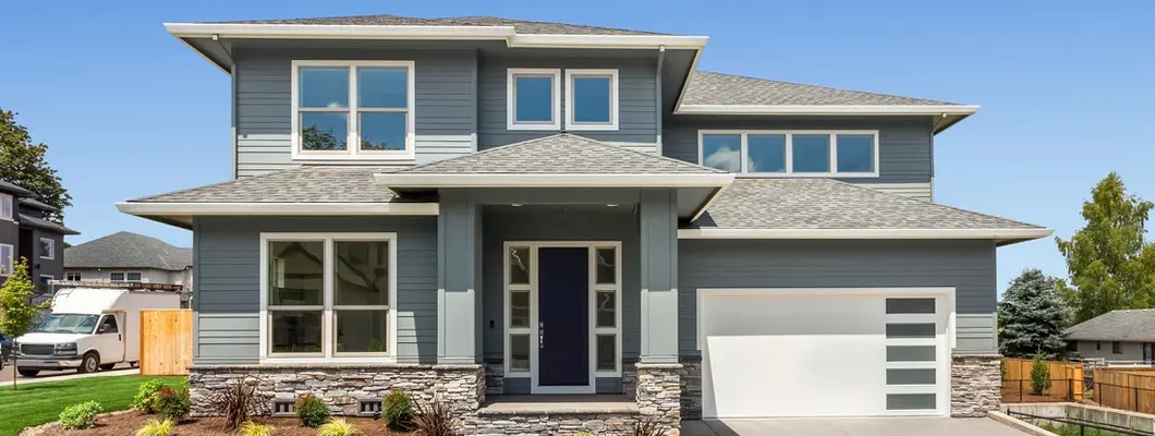 Beautiful suburban home exterior on bright sunny day with green grass and blue sky. Jefferson City, Missouri Homeowners Insurance.