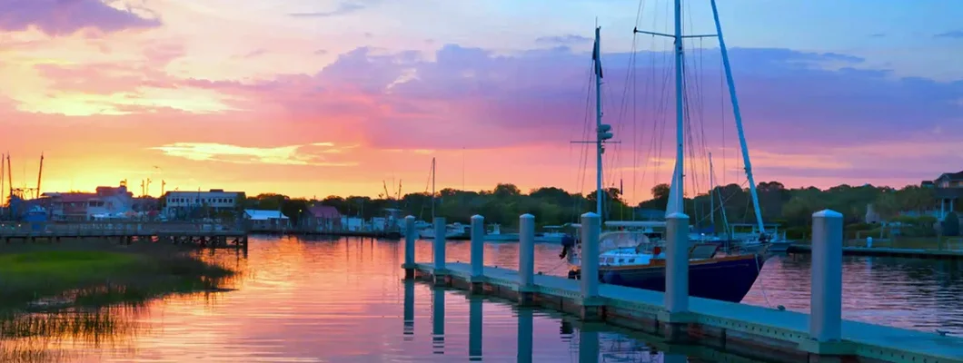 Sunrise Over A Docked Sailboat In Charleston South Carolina. Find South Carolina Boat Insurance.