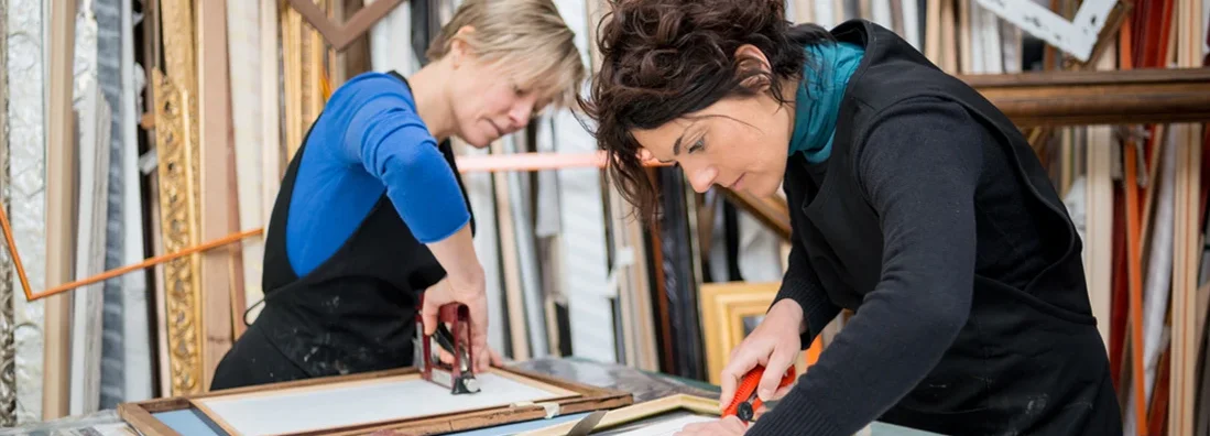 Restorer and framer laboratory craftswomen preparing frames. Find Rogers, Arkansas business insurance.
