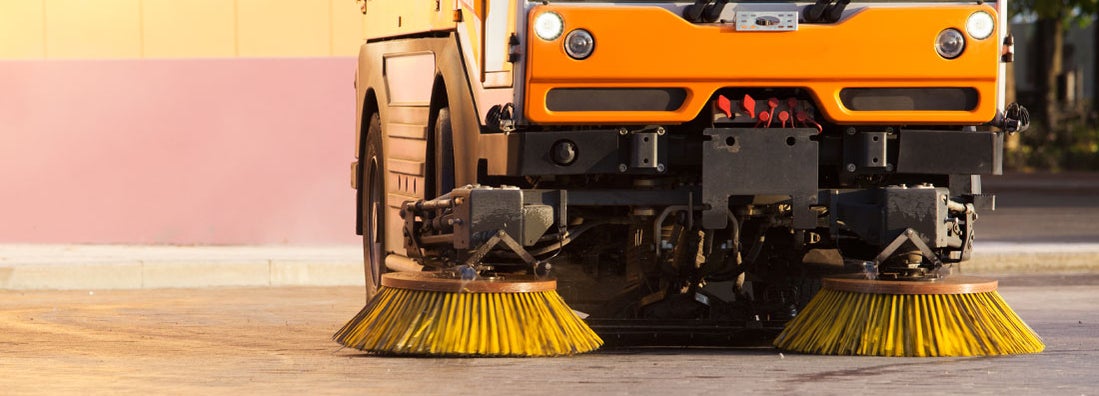 Parking garage sweeper cleans dirt with a round brush. Find parking lot and garage cleaning service insurance.