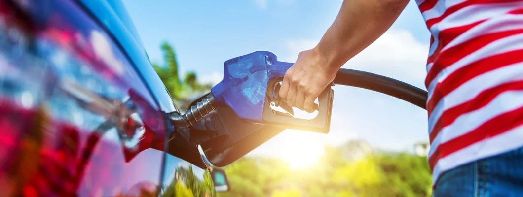 Woman fueling car. Buying Diesel? Pros and Cons to Consider. 