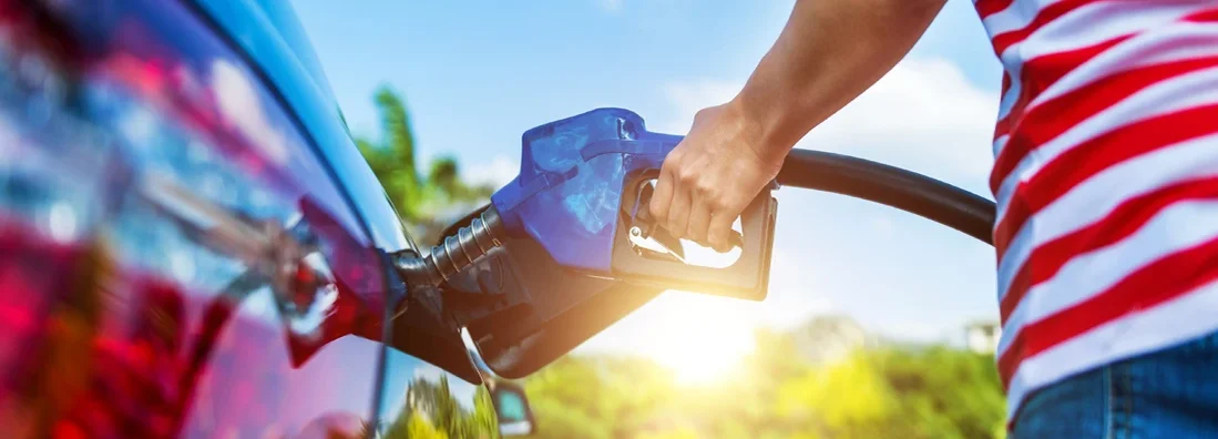 Woman fueling car. Buying Diesel? Pros and Cons to Consider. 