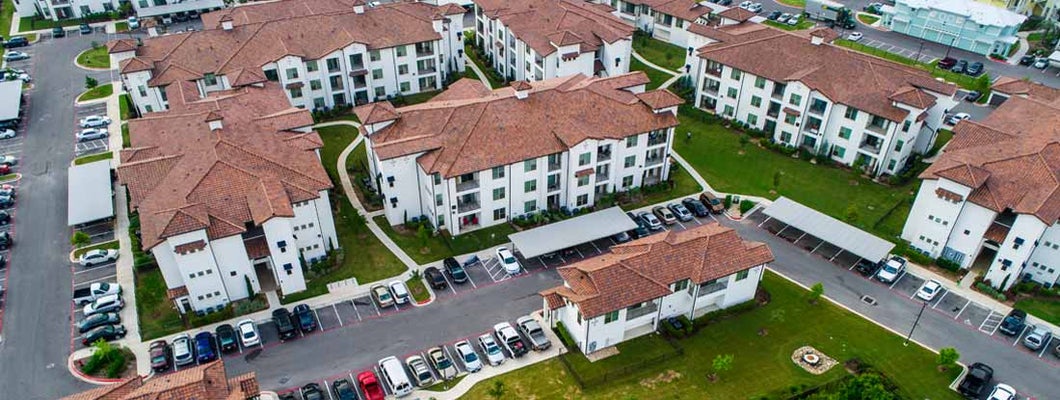 Aerial drone view above condo apartment buildings in Austin, Texas. Find Texas renters insurance.