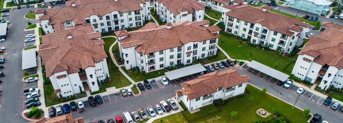 Aerial drone view above condo apartment buildings in Austin, Texas. Find Texas renters insurance.