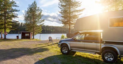 Pickup Truck Camper at Campsite. Find Truck Camper Insurance.