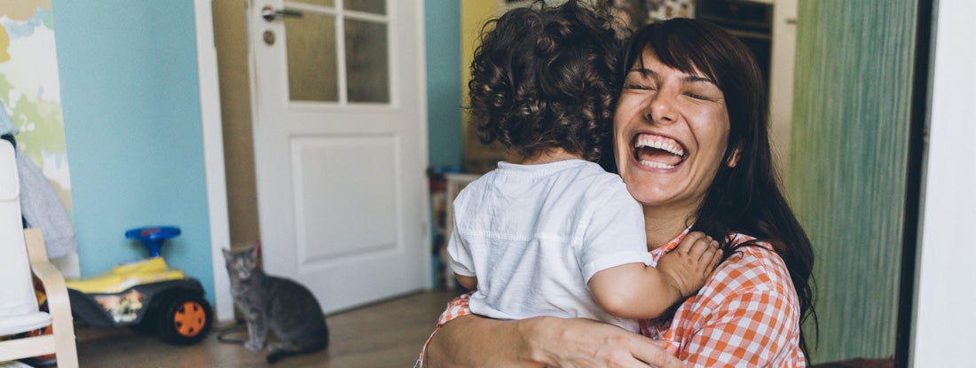 Mother and son hugging on the floor at home