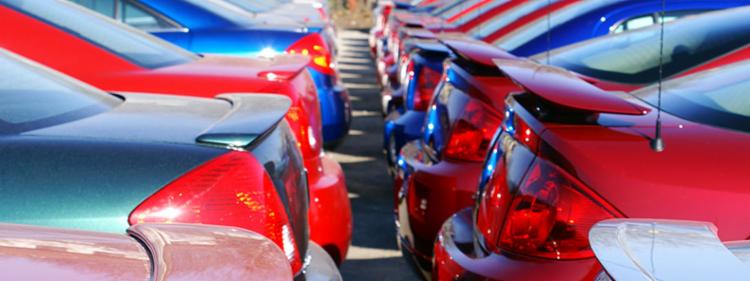 A line of cars at a dealership.