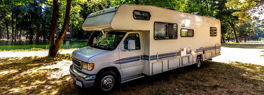 Family trip in RV in forest or park in Kansas. Find Kansas RV Insurance.