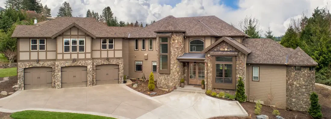 Large luxury home exterior on bright sunny day with blue sky. West Fargo, North Dakota Homeowners Insurance. 