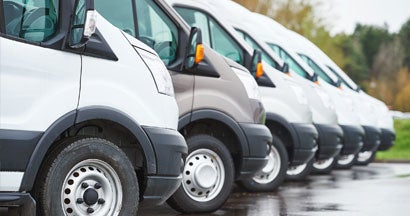 Commercial delivery vans in row. Find Commercial Auto Claims Insurance.