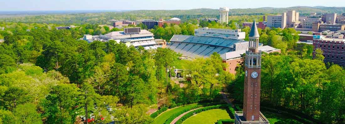 Aerial shot at UNC of the campus bell tower and football stadium.