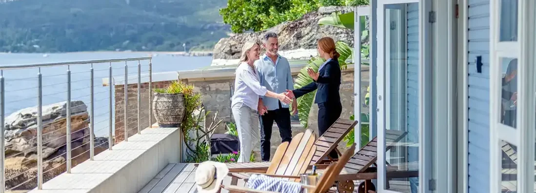 Landlord showing a mature couple rental house. Why Landlord Insurance Is Essential on Vacation Rental Homes.
