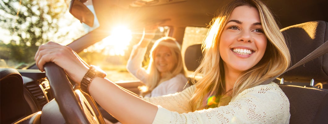 Teenage daughter and mother going on a family vacation in new car