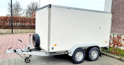 Trailer on an empty parking place. Choosing the Best Snowmobile Trailer.