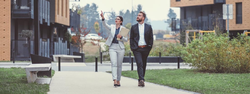 Property manager and customer looking at apartments.