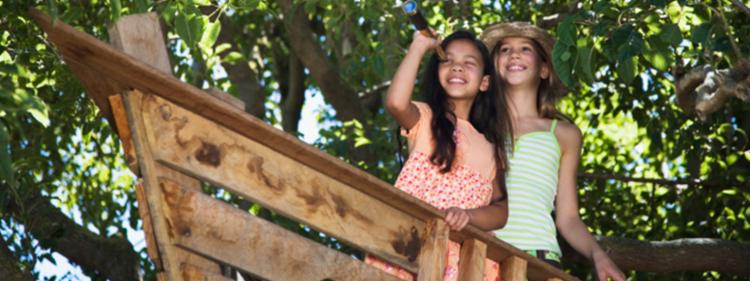 Girls sitting in a treehouse 