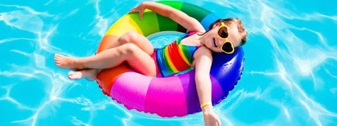 Child having fun on vacation at the swimming pool. 7 Absolutely Essential Summer Pool Safety Tips.