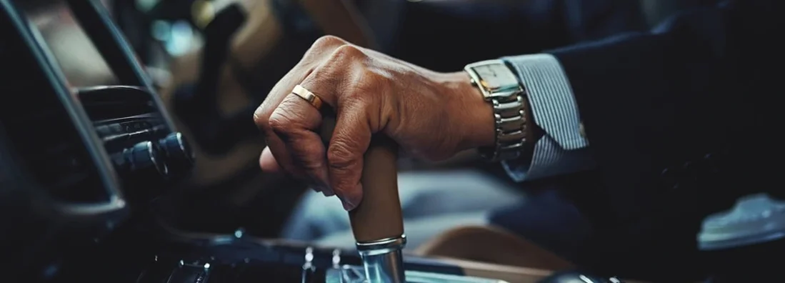 Cropped shot of a businessman changing the gears of a car. Mount Lebanon, Pennsylvania Car Insurance.