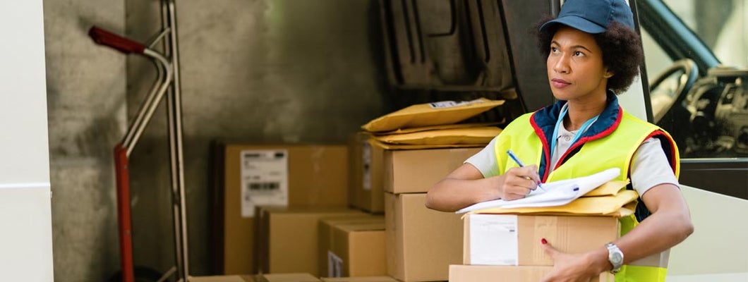 Courier getting ready for the delivery and checking package list by delivery. Find Federal Government Home Insurance.