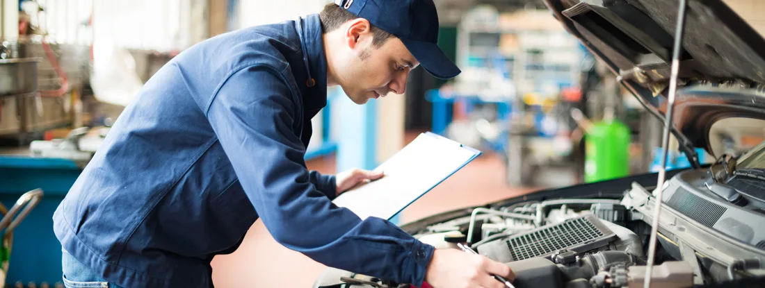 Portrait of a mechanic at work in his garage. Cars that are the cheapest to maintain.