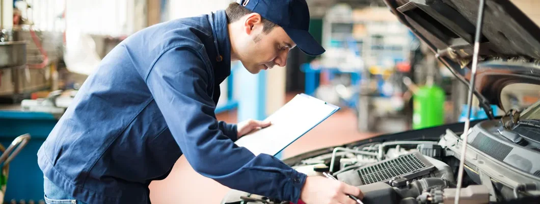 Portrait of a mechanic at work in his garage. Cars that are the cheapest to maintain. 