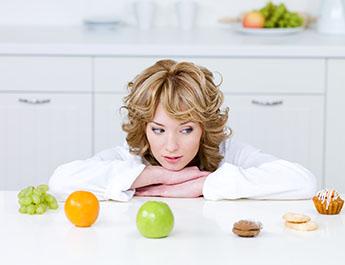 Woman trying to choose a healthy snack