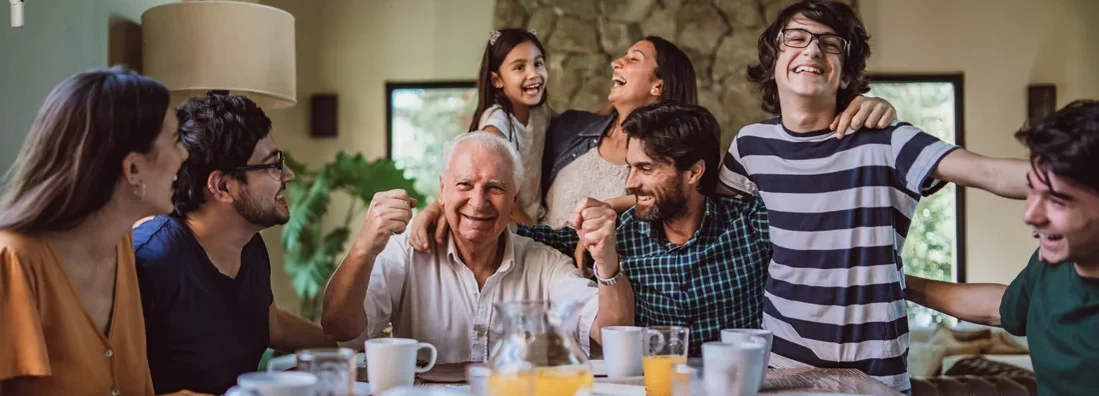Happy smiling grandfather surrounded with his big family at breakfast. The Best Way To Choose a Life Insurance Beneficiary.