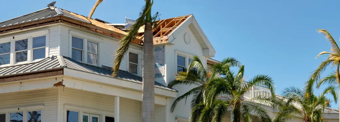 Damaged house roof after hurricane in Florida. How to calculate home replacement cost.