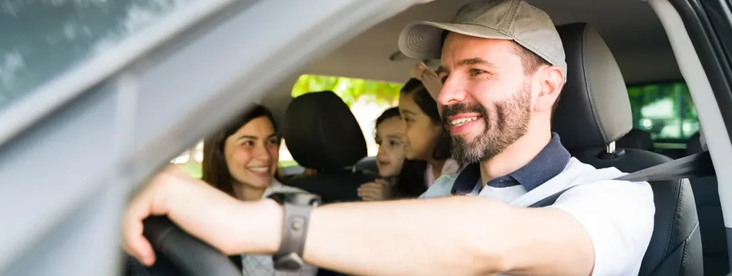 Husband driving family on vacation. Find East Providence, Rhode Island car insurance.