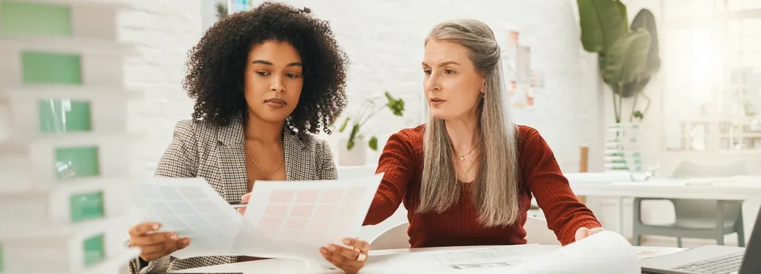 Team of designers reading documents together. How to Find the Best Business Insurance in Canby, Oregon.