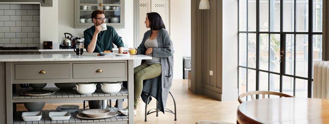 Young couple having breakfast together at new home