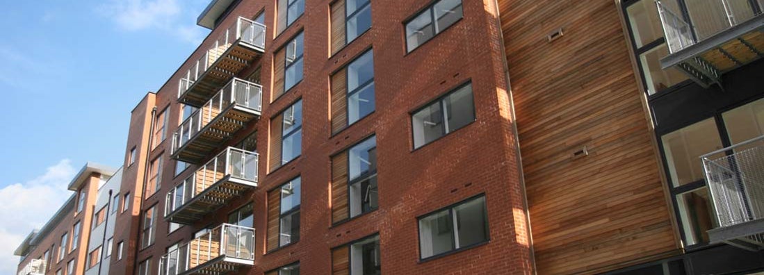 Rusty colored apartment building with wood accents. Find Charlotte North Carolina renters insurance.