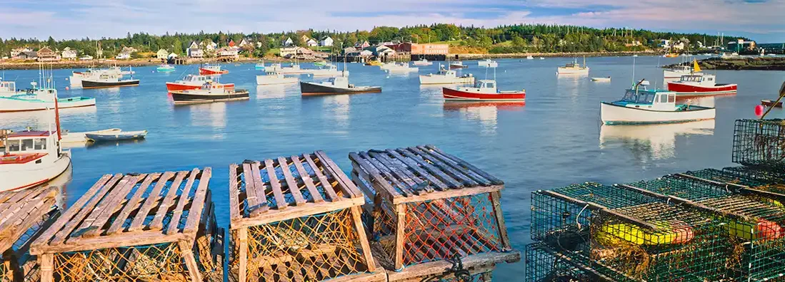 Wooden Lobster Traps On A Dock With Fishing Boats In Maine. Bath, Maine Business Insurance. 