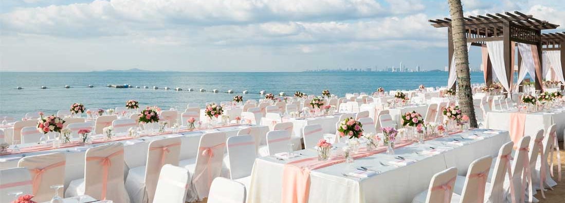 Wedding ceremony on the beach with rental tables and chairs