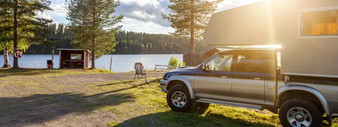 Pickup Truck Camper at Campsite. Find Truck Camper Insurance.