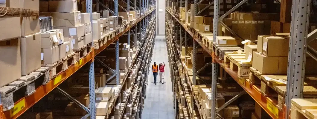 Warehouse manager walking with foremen checking stock on racks. Product Liability Insurance: What It Covers and How to Get It. 