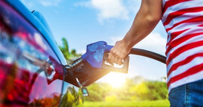 Woman fueling car. Buying Diesel? Pros and Cons to Consider. 
