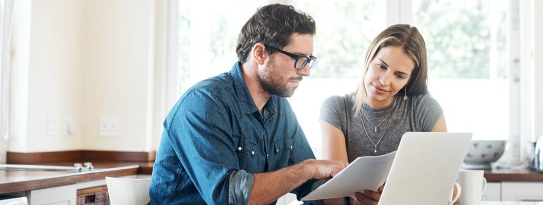 Young couple working on their finances together at home