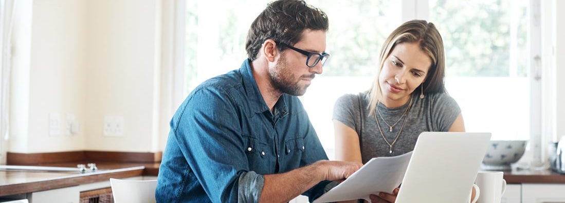 Young couple working on their finances together at home