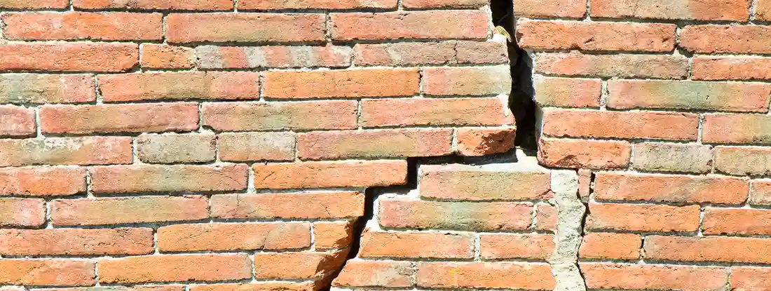 Deep crack in brick wall of home. Mine Subsidence Insurance.