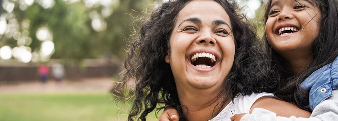 Happy mother having fun with her daughter at North Carolina park. Find Wilmington, North Carolina life insurance.